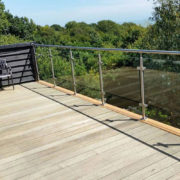 Brushed stainless steel post and handrail glass balustrade system